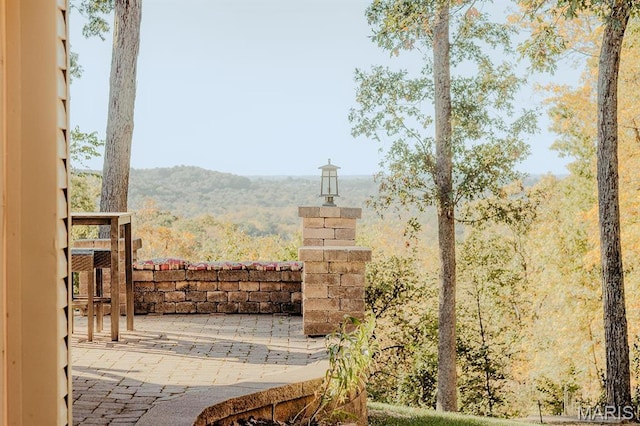 gate featuring a patio area and a mountain view