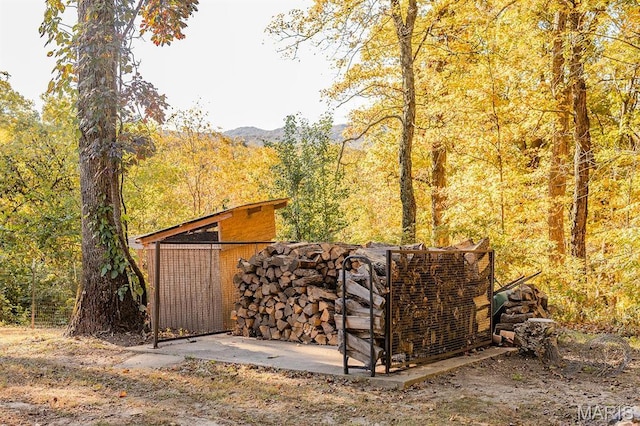 view of outbuilding with a view of trees and a mountain view