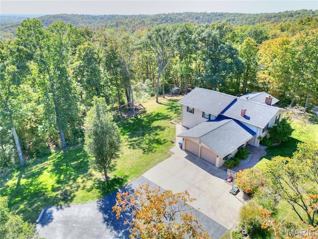view of subject property featuring a heavily wooded area