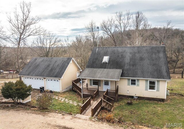 22125 Teak Ln, Saint Robert, MO 65584 - view of front of home with an outbuilding, a garage, covered porch, and roof with shingles