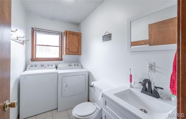 22125 Teak Ln, Saint Robert, MO 65584 - bathroom featuring washer and dryer, toilet, a textured ceiling, vanity, and tile patterned floors