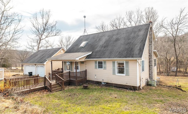22125 Teak Ln, Saint Robert, MO 65584 - back of property with central AC unit, roof with shingles, a lawn, a deck, and a garage