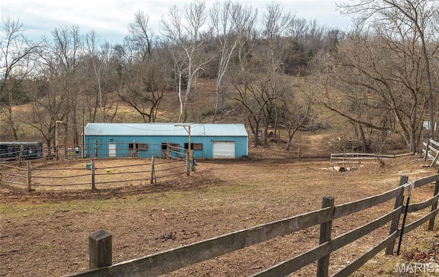 22125 Teak Ln, Saint Robert, MO 65584 - view of front of property with an outbuilding, an outdoor structure, a view of countryside, and a garage