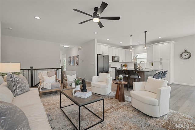 511 Kit Fox Ct, Eureka, MO 63025 - living room with light wood-style flooring, ceiling fan, baseboards, and recessed lighting