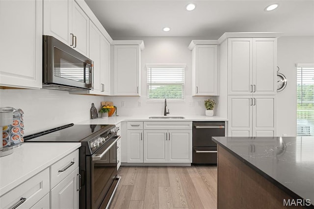511 Kit Fox Ct, Eureka, MO 63025 - kitchen with stainless steel microwave, black electric range oven, a sink, plenty of natural light, and recessed lighting