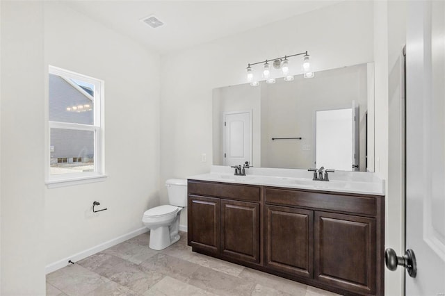 122 Harrow Dr, Ofallon, MO 63385 - bathroom featuring toilet, double vanity, and baseboards