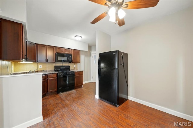 kitchen with black appliances, baseboards, dark wood-style floors, and ceiling fan