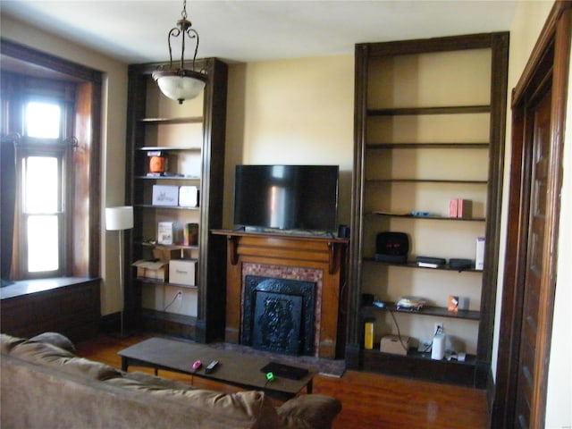 4528 Wichita Ave, Saint Louis, MO 63110 - living room with a fireplace, wood finished floors, and built in shelves