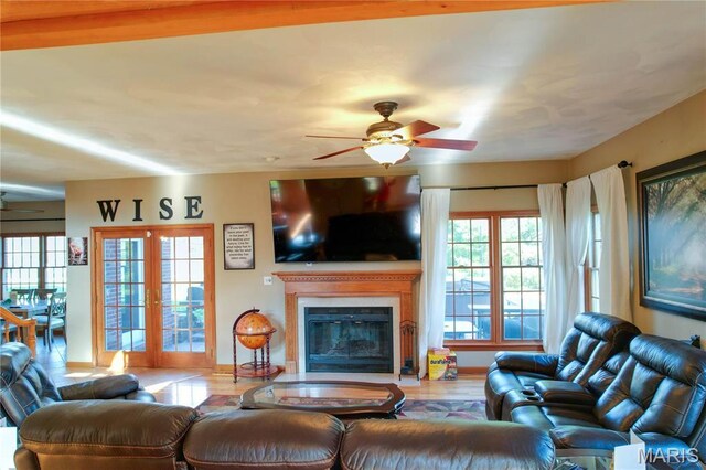 334 Spring Lake Rd, Millstadt, IL 62260 - living room featuring a ceiling fan, wood finished floors, baseboards, and a glass covered fireplace