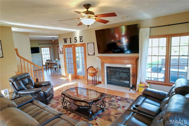 334 Spring Lake Rd, Millstadt, IL 62260 - living area featuring a ceiling fan, a glass covered fireplace, wood finished floors, and baseboards