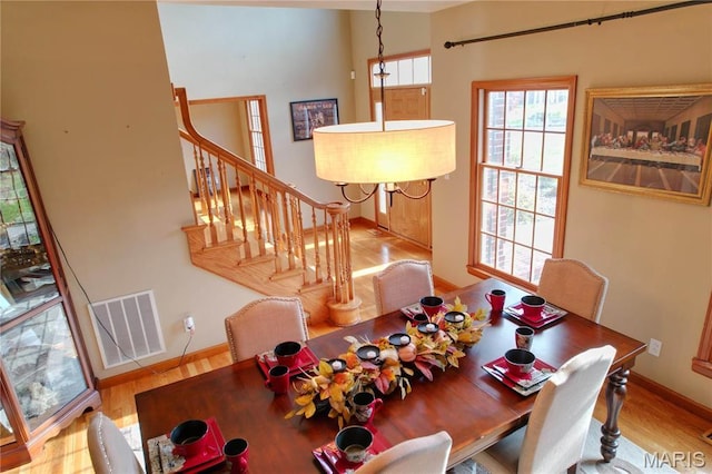 334 Spring Lake Rd, Millstadt, IL 62260 - dining space featuring baseboards, wood finished floors, and stairs