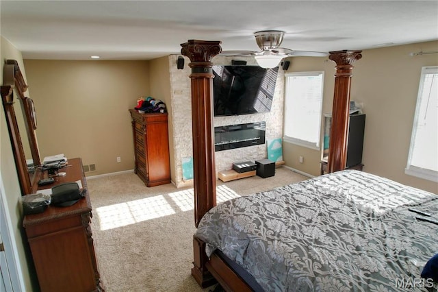 334 Spring Lake Rd, Millstadt, IL 62260 - bedroom featuring light carpet, multiple windows, baseboards, and a glass covered fireplace