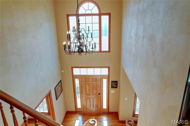 334 Spring Lake Rd, Millstadt, IL 62260 - entrance foyer with a towering ceiling, a chandelier, wood finished floors, and stairs
