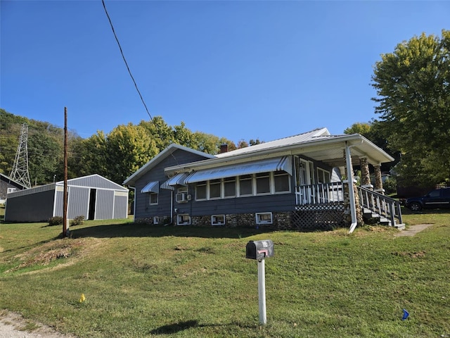 174 Clinton St, Hamburg, IL 62045 - view of front of home with a front lawn, a porch, and an outdoor structure