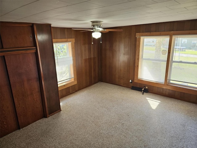 174 Clinton St, Hamburg, IL 62045 - unfurnished bedroom with light carpet, wooden walls, a closet, and ceiling fan