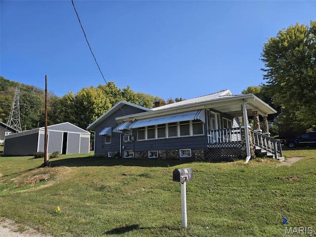 174 Clinton St, Hamburg, IL 62045 - view of front of property featuring a front lawn, covered porch, and an outbuilding