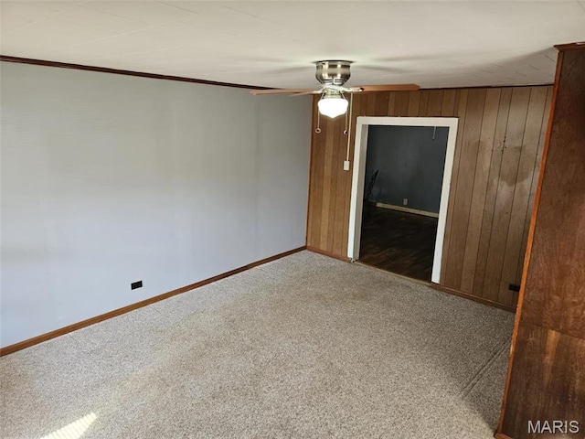 174 Clinton St, Hamburg, IL 62045 - unfurnished room with carpet flooring, wood walls, and a ceiling fan