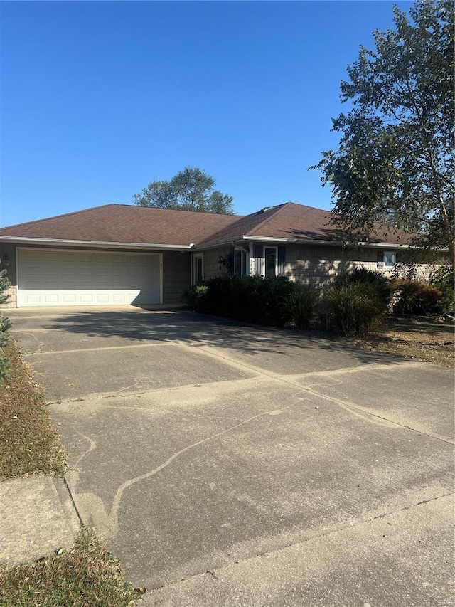 single story home with a garage and driveway