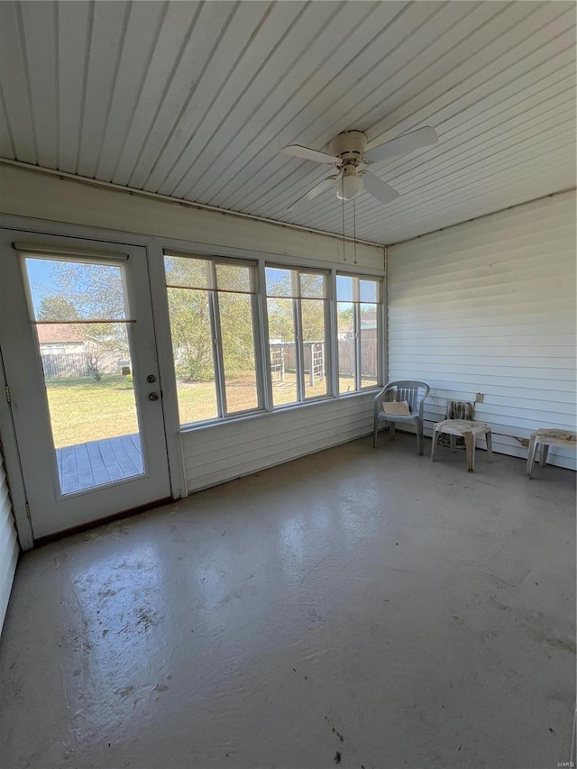unfurnished sunroom with a ceiling fan
