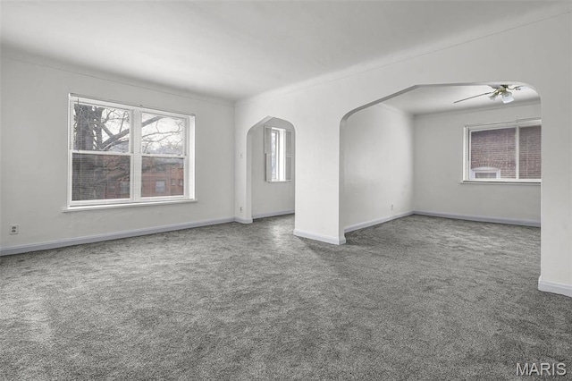 7273 Dartmouth Ave, Saint Louis, MO 63130 - spare room featuring carpet flooring, arched walkways, baseboards, and ceiling fan