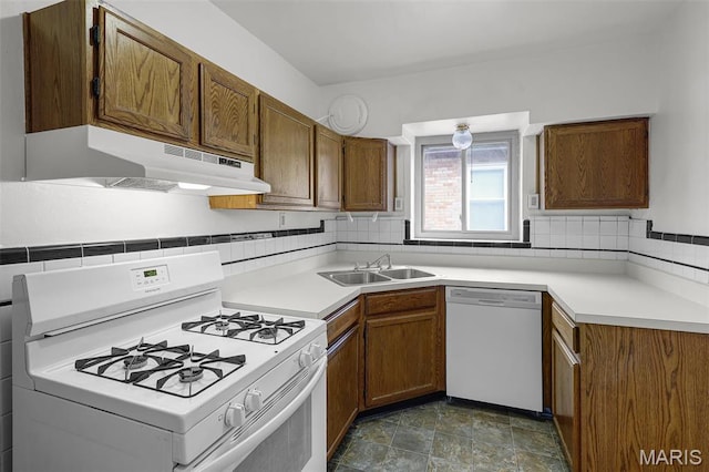 7273 Dartmouth Ave, Saint Louis, MO 63130 - kitchen featuring white appliances, under cabinet range hood, a sink, brown cabinets, and backsplash