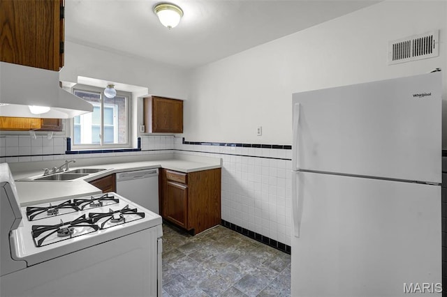 7273 Dartmouth Ave, Saint Louis, MO 63130 - kitchen featuring white appliances, a sink, tile walls, light countertops, and brown cabinets