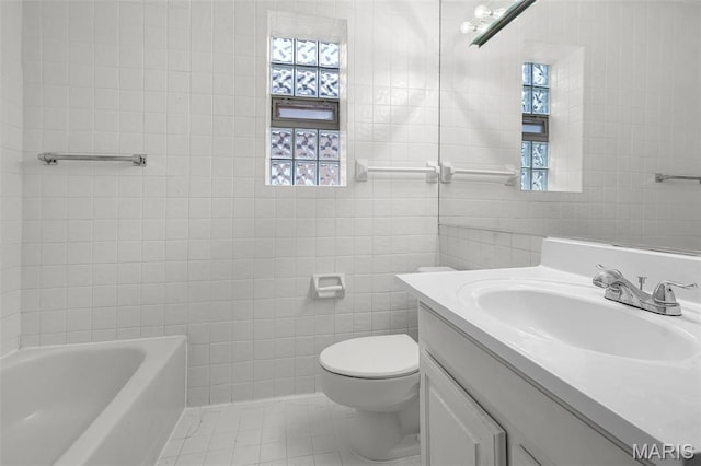 7273 Dartmouth Ave, Saint Louis, MO 63130 - bathroom with a tub to relax in, tile walls, toilet, vanity, and tile patterned floors