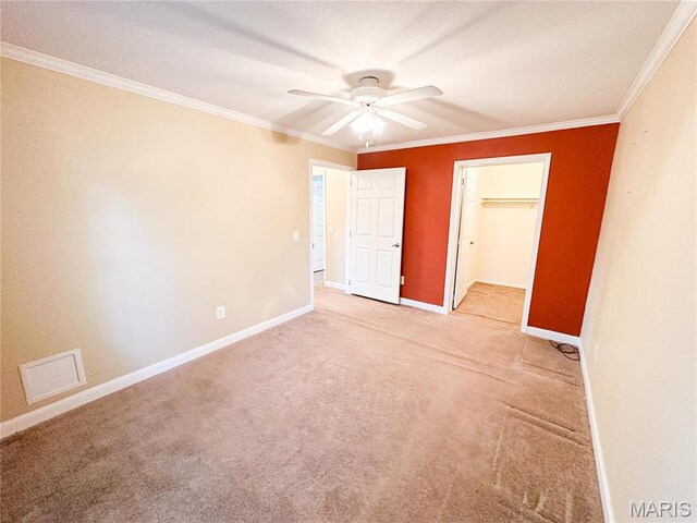 663 County Road 2590, Salem, MO 65462 - unfurnished bedroom with ornamental molding, light carpet, a ceiling fan, a closet, and a walk in closet