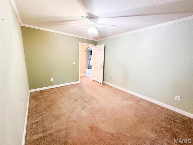 663 County Road 2590, Salem, MO 65462 - spare room featuring ceiling fan, light colored carpet, arched walkways, and crown molding