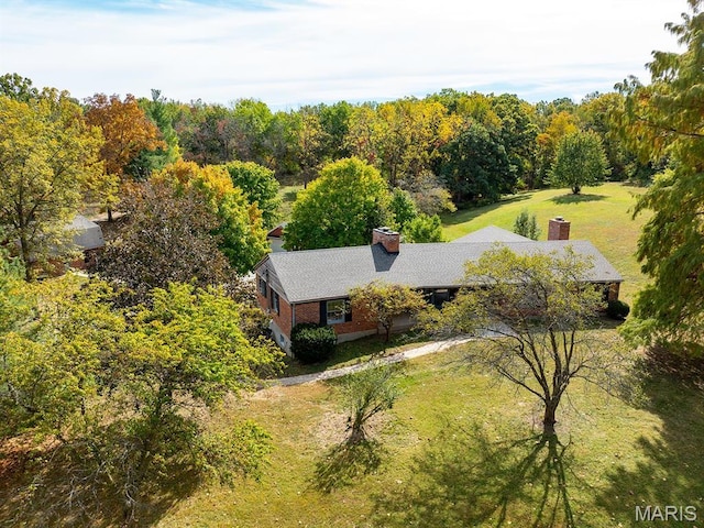 aerial view of property and surrounding area featuring a forest