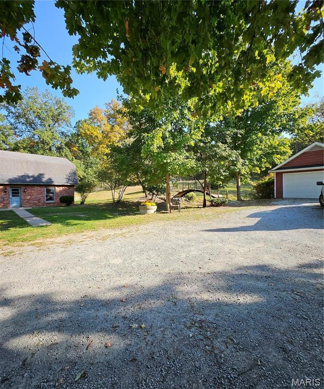 view of grassy yard featuring an outbuilding and a garage