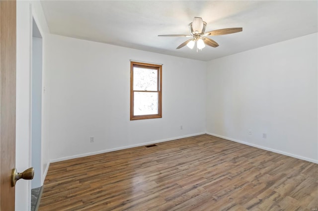 1145 Danby Rd, Festus, MO 63028 - unfurnished room with wood finished floors, a ceiling fan, and baseboards