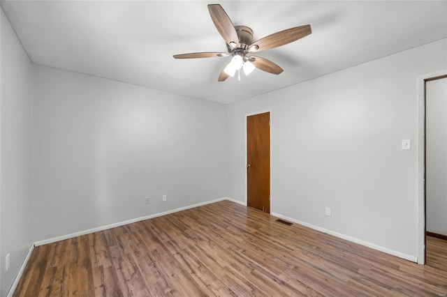 1145 Danby Rd, Festus, MO 63028 - spare room featuring wood finished floors, a ceiling fan, and baseboards