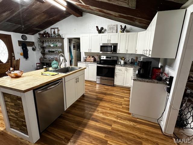 699 State Highway V, Sturdivant, MO 63782 - kitchen with stainless steel appliances, a sink, dark wood-type flooring, white cabinets, and an island with sink