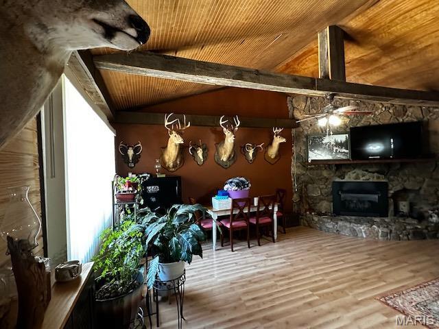 699 State Highway V, Sturdivant, MO 63782 - living room featuring wooden ceiling, wood finished floors, a stone fireplace, and a ceiling fan