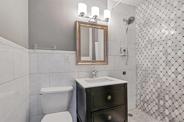 4466 W Pine Blvd Unit 3E, Saint Louis, MO 63108 - full bathroom with tile walls, a tile shower, vanity, and toilet