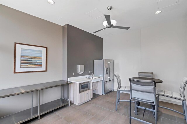 4466 W Pine Blvd Unit 3E, Saint Louis, MO 63108 - kitchen featuring appliances with stainless steel finishes, light countertops, modern cabinets, a ceiling fan, and light tile patterned floors