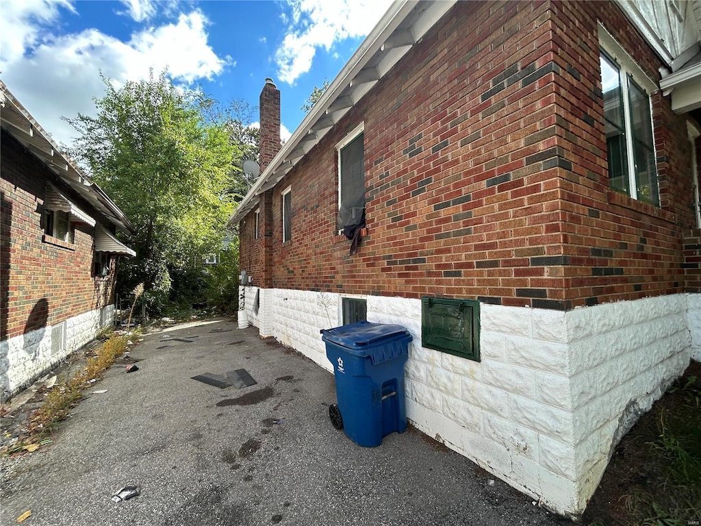 4228 Jennings Station Rd, Saint Louis, MO 63121 - view of side of property featuring a chimney and brick siding