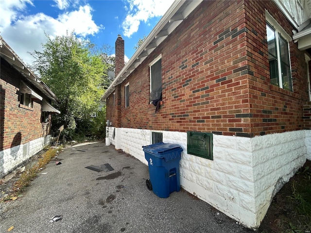 4228 Jennings Station Rd, Saint Louis, MO 63121 - view of side of property featuring a chimney and brick siding