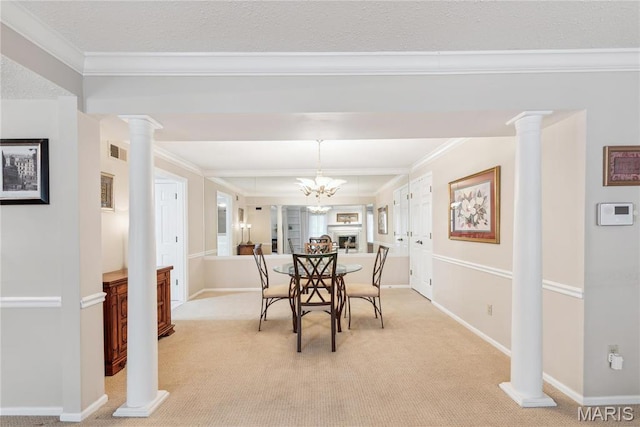 964 Claytonbrook Dr Unit 2A, Ballwin, MO 63011 - dining area featuring ornamental molding, light colored carpet, ornate columns, baseboards, and a chandelier