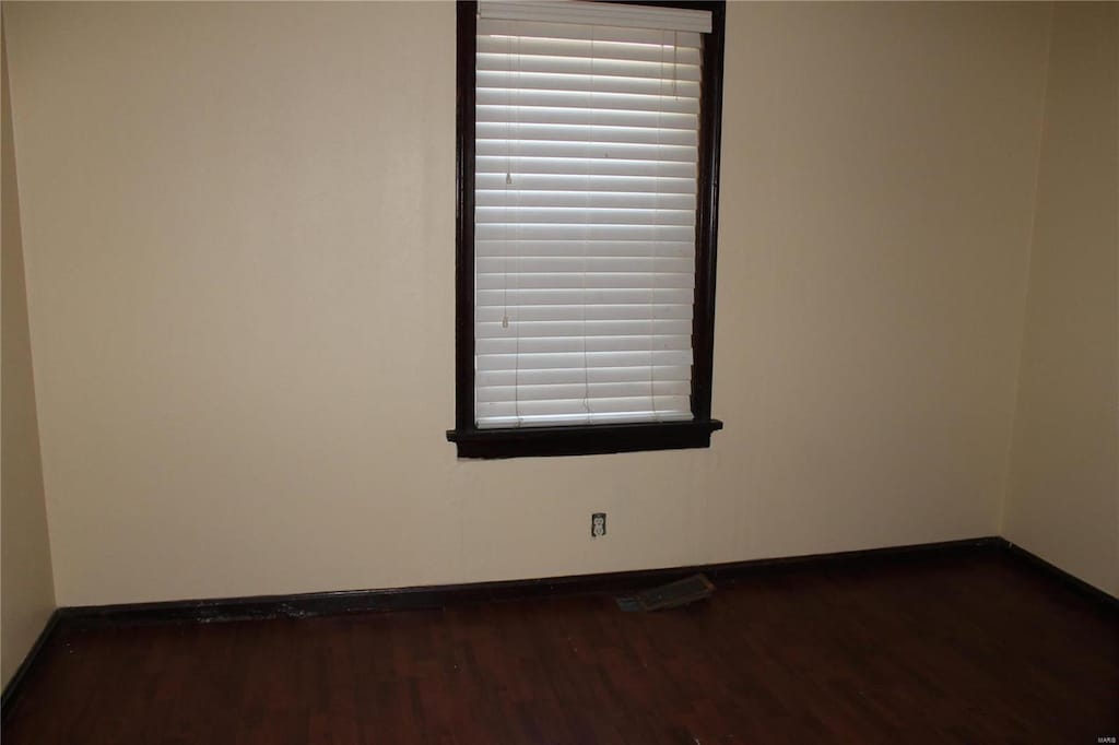 11814 Bellefontaine Rd, Saint Louis, MO 63138 - unfurnished room featuring baseboards and dark wood-style flooring