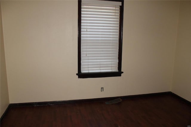 11814 Bellefontaine Rd, Saint Louis, MO 63138 - unfurnished room featuring baseboards and dark wood-style flooring