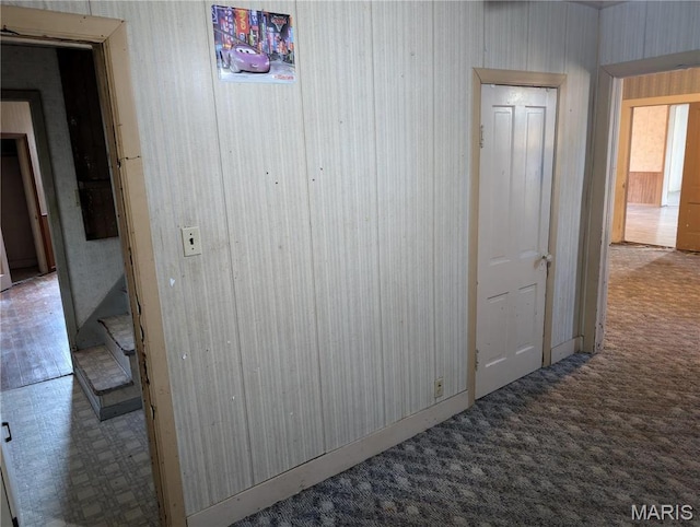 hallway with tile patterned floors and carpet floors