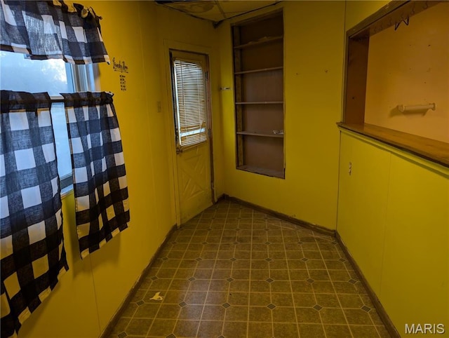 corridor featuring dark flooring