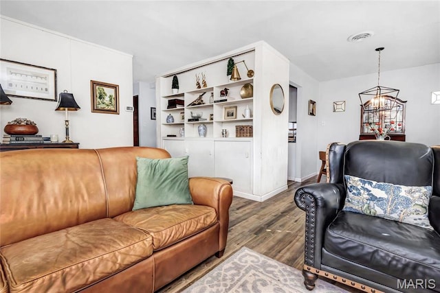 11409 Manchester Rd, Saint Louis, MO 63122 - living area featuring wood finished floors, a chandelier, and baseboards