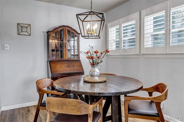11409 Manchester Rd, Saint Louis, MO 63122 - dining space with baseboards, wood finished floors, and a chandelier