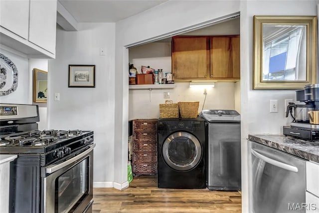 11409 Manchester Rd, Saint Louis, MO 63122 - kitchen featuring stainless steel appliances, wood finished floors, brown cabinetry, separate washer and dryer, and baseboards