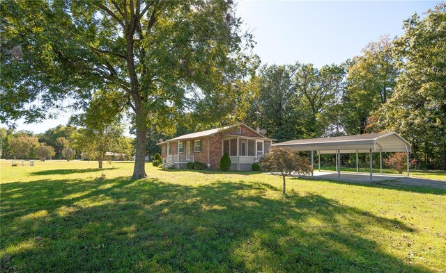12191 County Road 637, Dexter, MO 63841 - view of front of home with a carport, a front yard, and brick siding
