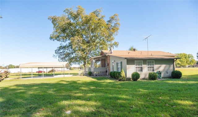 12191 County Road 637, Dexter, MO 63841 - back of house featuring a lawn and a carport
