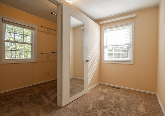 12191 County Road 637, Dexter, MO 63841 - unfurnished bedroom featuring carpet, baseboards, crown molding, a textured ceiling, and a closet